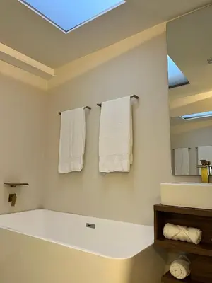a bathroom with a bath tub and towels on the wall at One Apartments Provenza in Medellín