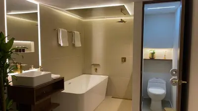 a bathroom with a white toilet and a sink at One Apartments Provenza in Medellín