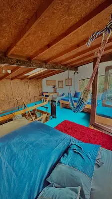 a room with a bed and a hammock in it at Lodge Kumbre Santa Elena Bosque Privado in Medellín