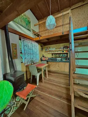 a kitchen with a table and a stove in a room at Lodge Kumbre Santa Elena Bosque Privado in Medellín