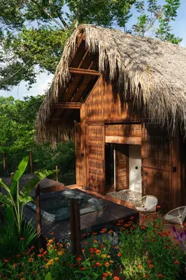 a hut with a thatched roof with a cat in it at Sandagua Hotel-Doradal, Antioquia in Puerto Triunfo