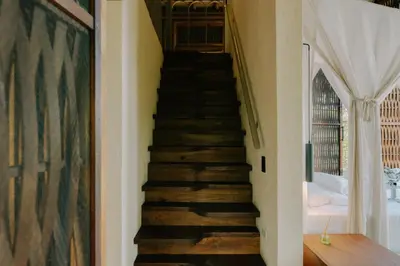 a stairway in a home with wooden stairs at Sandagua Hotel-Doradal, Antioquia in Puerto Triunfo