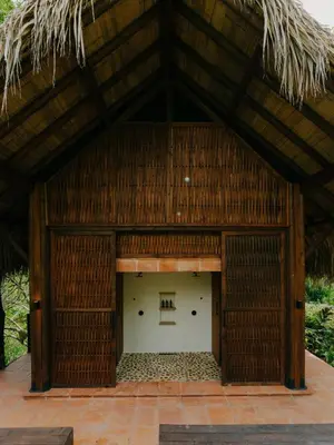 a large building with a thatched roof at Sandagua Hotel-Doradal, Antioquia in Puerto Triunfo