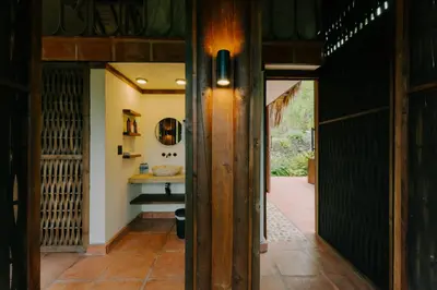 a hallway leading to a bathroom with a sink at Sandagua Hotel-Doradal, Antioquia in Puerto Triunfo