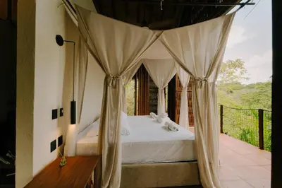 a bedroom with a bed with a canopy at Sandagua Hotel-Doradal, Antioquia in Puerto Triunfo