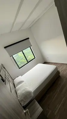 a bedroom with a large bed and a window at ZOI Eco Hotel y Glamping in Manizales