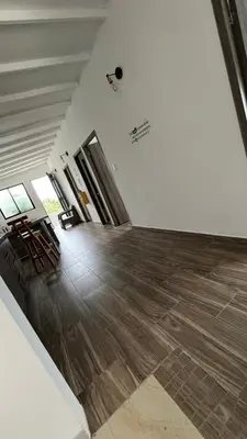 an empty room with chairs and a wooden floor at ZOI Eco Hotel y Glamping in Manizales