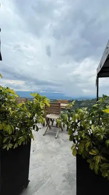 a wooden bench sitting on top of a balcony at ZOI Eco Hotel y Glamping in Manizales