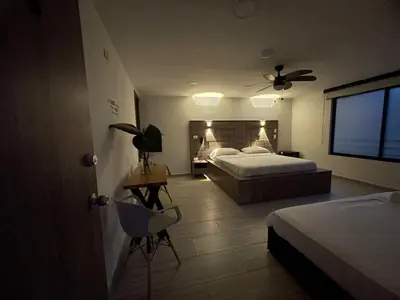 a bedroom with two beds and a ceiling fan at ZOI Eco Hotel y Glamping in Manizales