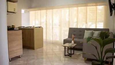 a living room with a couch and a table at 2 Cuadras Estadio - La 70, Laureles, 700MB, AC in Medellín