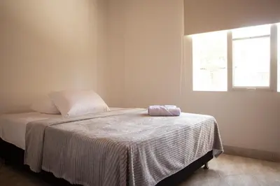 a bedroom with a bed with a blanket on it at 2 Cuadras Estadio - La 70, Laureles, 700MB, AC in Medellín