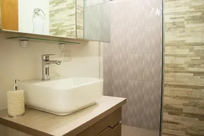 a bathroom with a white sink and a mirror at 2 Cuadras Estadio - La 70, Laureles, 700MB, AC in Medellín