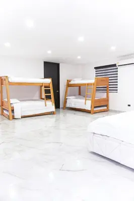 two bunk beds in a room with white tile floors at Finca golden house en santa fe de antioquia in El Espinal