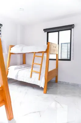 a bunk bed in a room with a window at Finca golden house en santa fe de antioquia in El Espinal