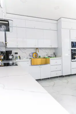 a white kitchen with white cabinets and appliances at Finca golden house en santa fe de antioquia in El Espinal