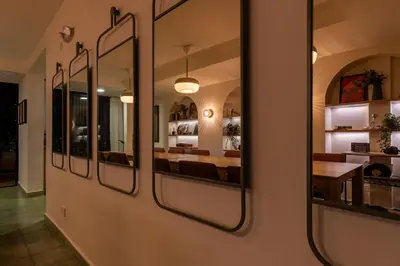 a dining room with mirrors on a wall at 103 Design Loft Escape Hammock AC & Great Vibes in Medellín
