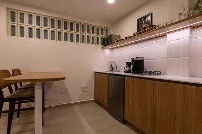a kitchen with a table and a counter top at 103 Design Loft Escape Hammock AC & Great Vibes in Medellín