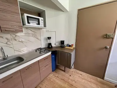a small kitchen with a sink and a microwave at Espectacular apartaestudio en envigado cerca de todo in Envigado