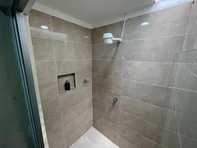a bathroom with a shower with a glass door at Espectacular apartaestudio en envigado cerca de todo in Envigado