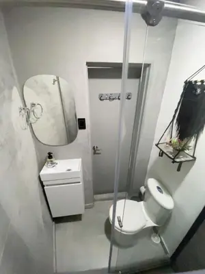 a bathroom with a toilet and a sink and a mirror at Espectacular apartaestudio en envigado cerca de todo in Envigado