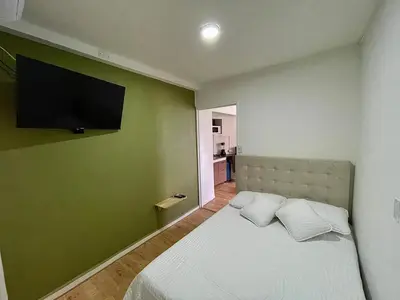 a bedroom with a bed with a flat screen tv on the wall at Espectacular apartaestudio en envigado cerca de todo in Envigado