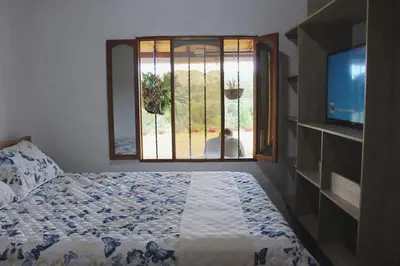a bedroom with a bed and a window at Alma Casa Finca in Guarne