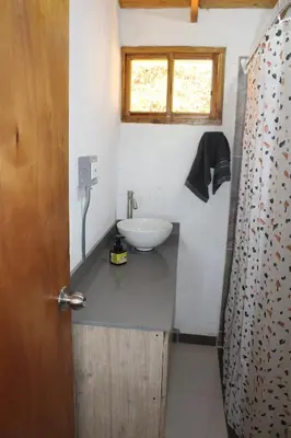 a small bathroom with a sink and a window at Alma Casa Finca in Guarne