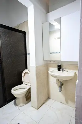 a bathroom with a toilet and a sink at La Esquinita de Miraflores in Medellín