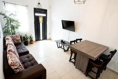 a living room with a couch and a table at La Esquinita de Miraflores in Medellín