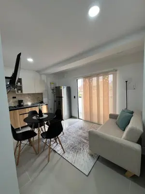 a living room with a couch and a table at Apartamento 2 habitaciones en la América in Medellín