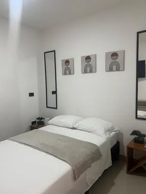 a bedroom with a bed and three pictures on the wall at Apartamento 2 habitaciones en la América in Medellín