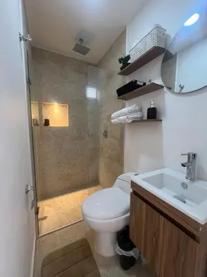 a bathroom with a toilet and a shower and a sink at Apartamento 2 habitaciones en la América in Medellín