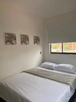 two beds sitting next to each other in a bedroom at Apartamento 2 habitaciones en la América in Medellín