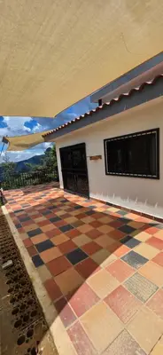 a room with a checkered floor in front of a building at Casa Campestre Tara in Barbosa