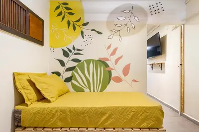 a bedroom with a yellow bed in a room at Envigado Centro Piso 1 in Envigado