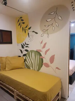 a bedroom with a yellow bed in a room at Envigado Centro Piso 1 in Envigado