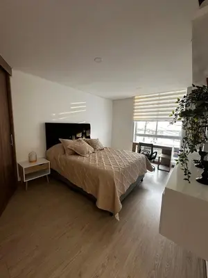 a bedroom with a bed and a large window at Apartamento moderno ubicado en zona exclusiva in Manizales