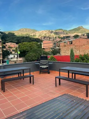 two benches sitting on a patio with a grill at Dúplex Céntrico Con Servicios Premium in Medellín