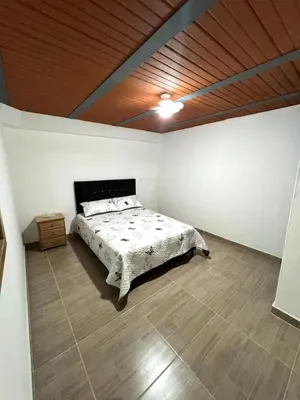 a bedroom with a bed and a wooden ceiling at Dúplex Céntrico Con Servicios Premium in Medellín