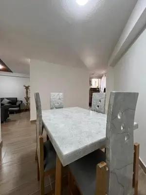 a dining table and chairs in a living room at Dúplex Céntrico Con Servicios Premium in Medellín