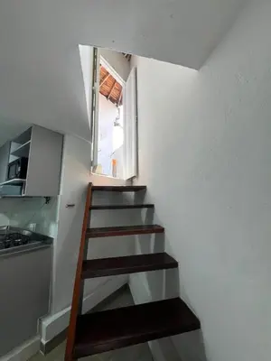 a staircase in a small room with a window at Dúplex Céntrico Con Servicios Premium in Medellín
