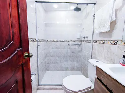 a bathroom with a shower with a toilet and a sink at Casa de Confort con Parqueadero Privado in Medellín