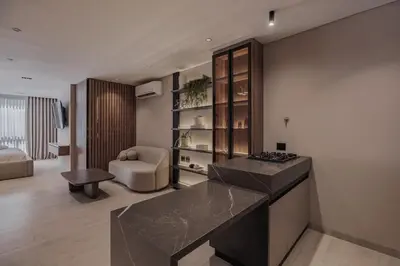a kitchen with a counter and a living room at Modern & Elegant Loft in El Poblado 217 in Medellín