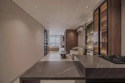 a kitchen with a counter top and a living room at Modern & Elegant Loft in El Poblado 217 in Medellín