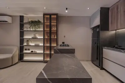 a kitchen with a counter and a refrigerator at Modern & Elegant Loft in El Poblado 217 in Medellín