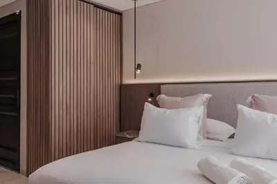 a bedroom with a bed with white sheets and pillows at Modern & Elegant Loft in El Poblado 217 in Medellín