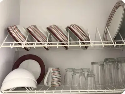 a shelf with plates and dishes in a kitchen at 1008 New Apartment in Poblado, panoramic view in Medellín