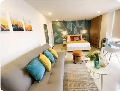 a living room with a couch and a bed at 1008 New Apartment in Poblado, panoramic view in Medellín