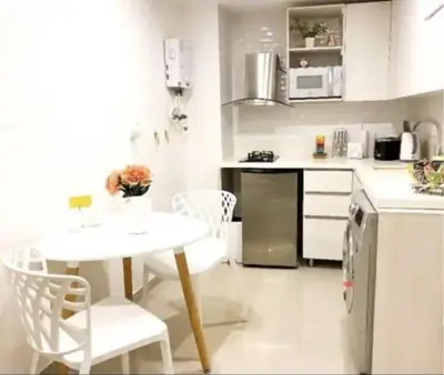 a kitchen with a white table and chairs and a table and a refrigerator at 1008 New Apartment in Poblado, panoramic view in Medellín