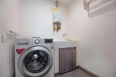 a washing machine in a laundry room with a sink at Luxury Apartment Poblado in Medellín